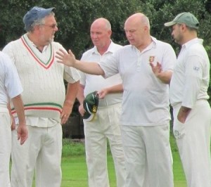 Tim demonstrates to team mates how far outside off stump the ball that he was given out lbw to had pitched.